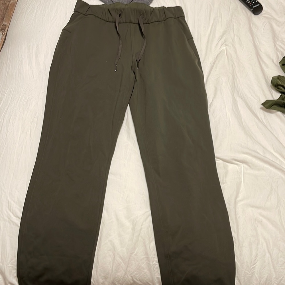 Olive green boot cut athletic pants .